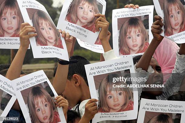 Moroccan children hold placards showing portraits of Madeleine McCann, the British girl who vanished in Portugal more than a month ago, 11 June 2007,...