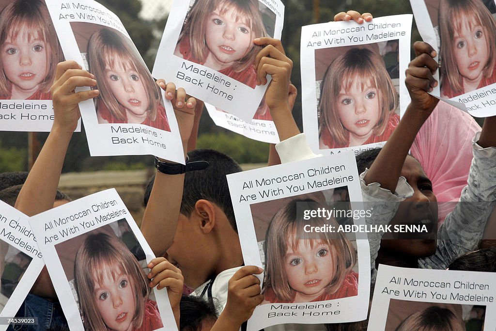 Moroccan children hold placards showing...