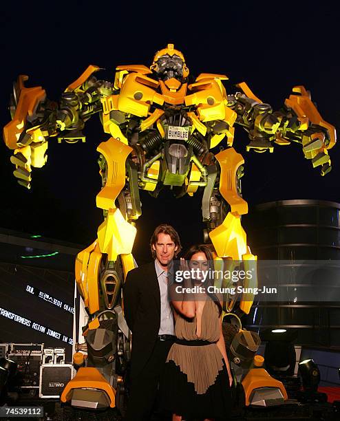 Film director Michael Bay and actress Megan Fox attend in front of Bumble Bee before a press conference to promote their new film "Transformers" on...