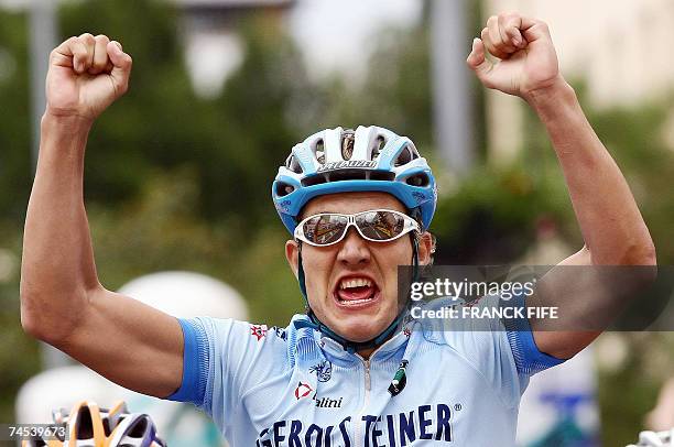 German rider Heinrich Haussler raises his arms in victory as he crosses the finish line of the Dauphine Libere Criterium first stage, 11 June 2007 in...