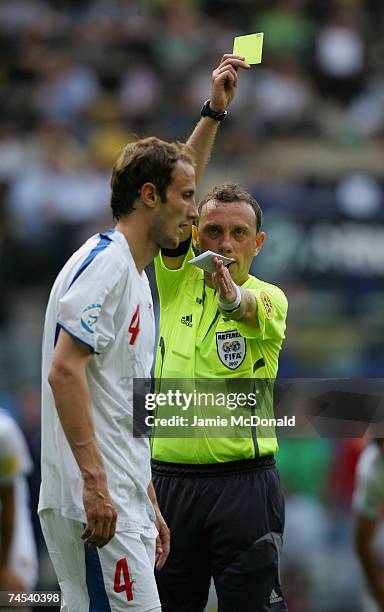 Referee Zsolt Szabo awards Roman Hubnik of Czech Republic a yellow card during the UEFA U21 Championship, group B match between Czech Republic U21...