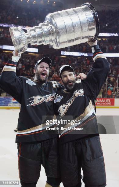 Rob Niedermayer of the Anaheim Ducks and brother Scott Niedermayer hoist the Stanley Cup after their team's victory over the Ottawa Senators in Game...