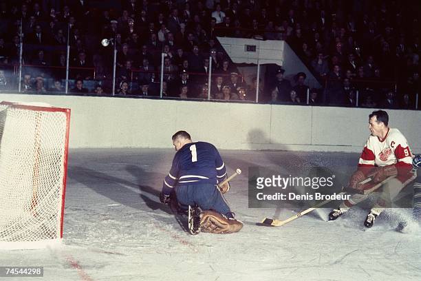 S: Gordie Howe of the Detroit Red Wings scores a goal against Johnny Bower of the Toronto Maple Leafs during their NHL game in Toronto, Canada.
