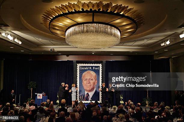 Postmaster General Jack Potter, U.S. Vice President Dick Cheney, and Ford's children Susan Ford Bales, Steve Ford, Jack Ford and Mike Ford applaud...