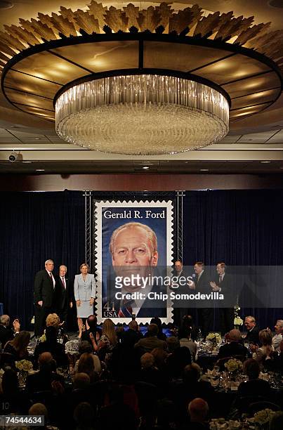 Postmaster General Jack Potter, U.S. Vice President Dick Cheney, and Ford's children Susan Ford Bales, Steve Ford, Jack Ford and Mike Ford applaud...