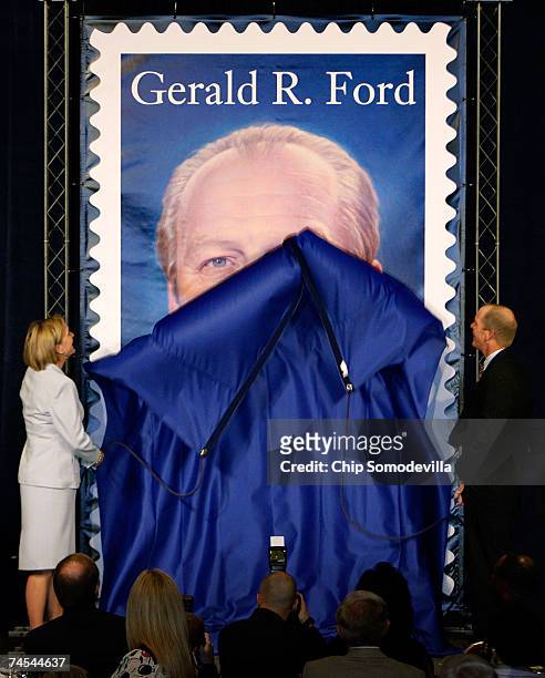 Former U.S. President Gerald R. Ford's children Susan Ford Bales and Steve Ford unveil the new commemorative stamp with the image of former U.S....