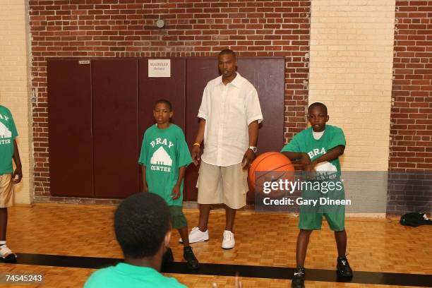 Caron Butler of the Washington Wizards teaches basketball passing skills to children during the Caron Butler 3D Youth Basketball Camp on June 11,...