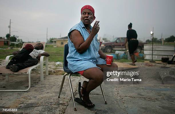 Janice Miller smokes outside the old motor home she is currently living in with three other people in the Lower Ninth Ward June 10, 2007 in New...