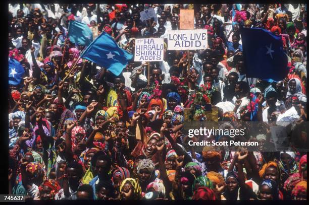 Demonstrators cheer at a rally for General Mohammad Farrah Aidid October 14, 1993 in Mogadishu, Somalia. A powerful warlord, Aidid continues to rally...