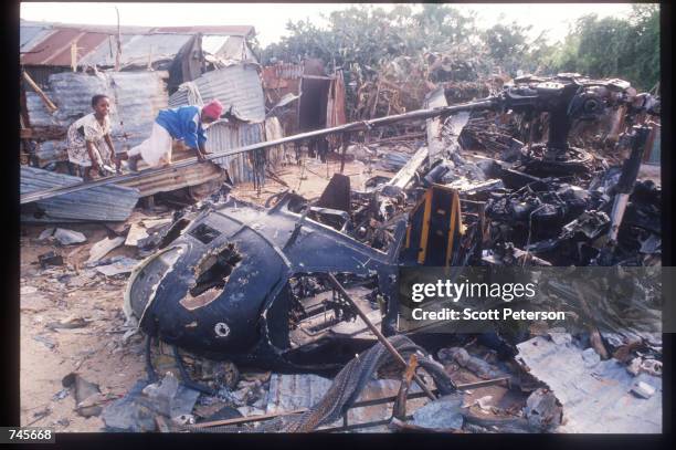 Children climb along the rotor of a wrecked American helicopter October 14, 1993 in Mogadishu, Somalia. This Blackhawk helicopter, which was used to...