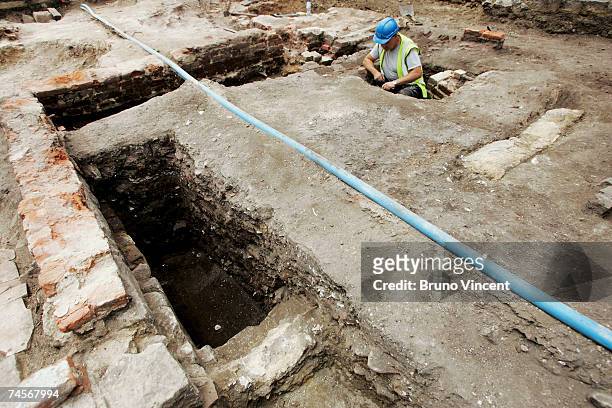Archaeologists record a dig in the grounds of the Tower of London on June 12, 2007 in London. The remains, of what appears to be a cellar, were...