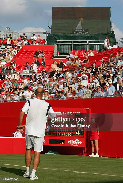 Ivan Ljubicic of Croatia watches the screen displaying a hawkeye decision during the second round singles match against Danai Udomchoke of Thailand...