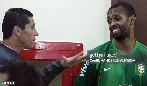 El arquero de la seleccion brasilena de futbol Helton , escucha al auxiliar tecnico Jorginho durante un entrenamiento fisico en la Granja Comary en...
