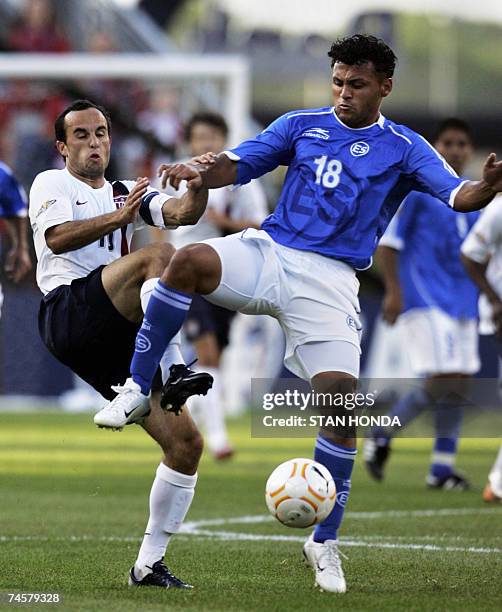 Foxboro, UNITED STATES: Landon Donovan of the USA fights for the ball with Alexander Escobar of El Salvador during a first round game at the CONCACAF...