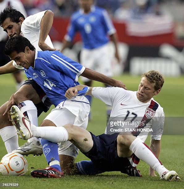 Foxboro, UNITED STATES: Jonathan Spector and Pablo Mastroeni of the USA fight for the ball against Ramon Sanchez of El Salvador during a first round...