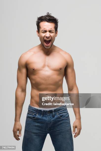 bare-chested hispanic man yelling - sin camisa fotografías e imágenes de stock