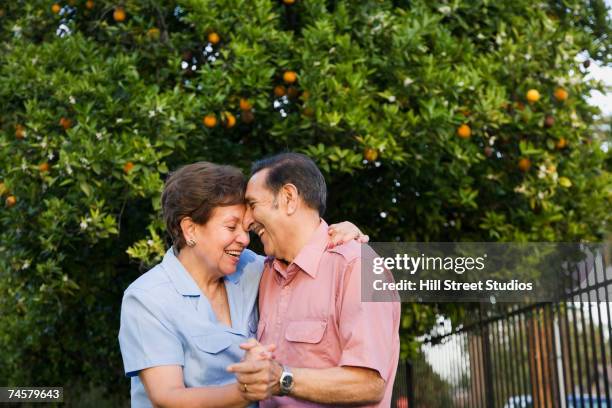 senior hispanic couple dancing outdoors - hispanic couple stock pictures, royalty-free photos & images