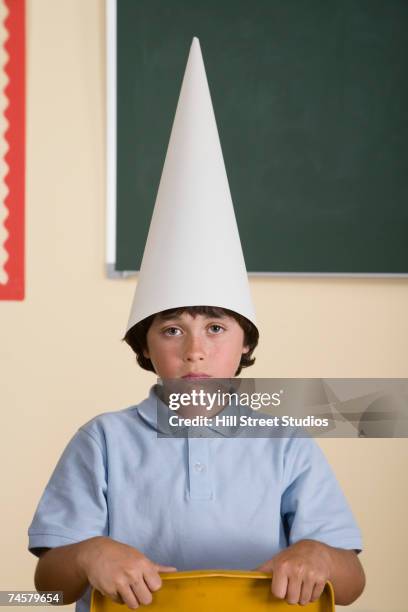 hispanic boy wearing dunce hat - dumstrut bildbanksfoton och bilder