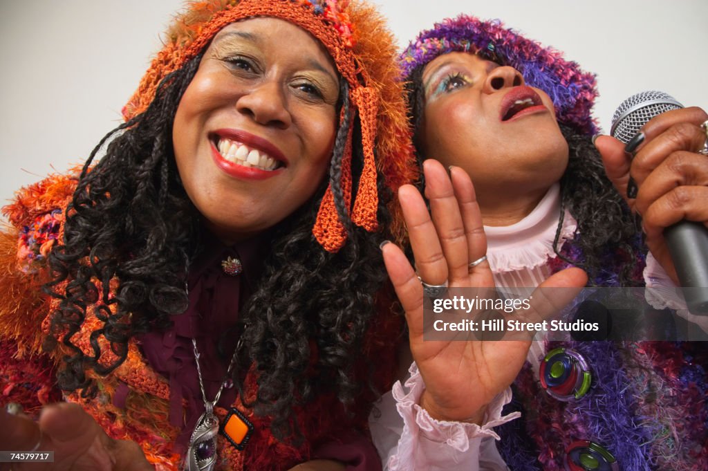 Two senior African women singing