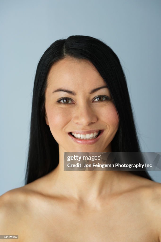 Portrait of Asian woman with bare shoulders