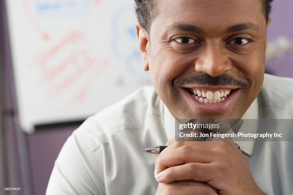 Close up of African businessman smiling