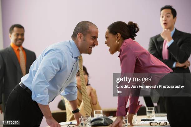 businesspeople yelling at each other - disagreement at work stock-fotos und bilder