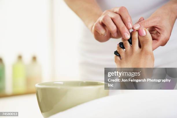 woman receiving spa treatment - pedicure foto e immagini stock