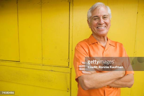 senior hispanic man with arms crossed - 60 65 man stock pictures, royalty-free photos & images