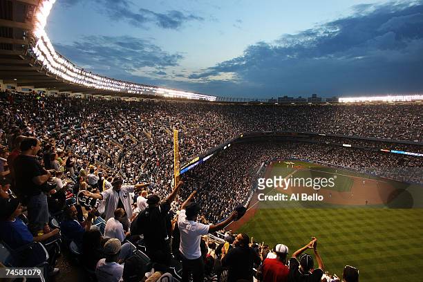The crowd reacts to a three-run home run by Bobby Abreu of the New York Yankees against the Arizona Diamondbacks during the third inning of their...