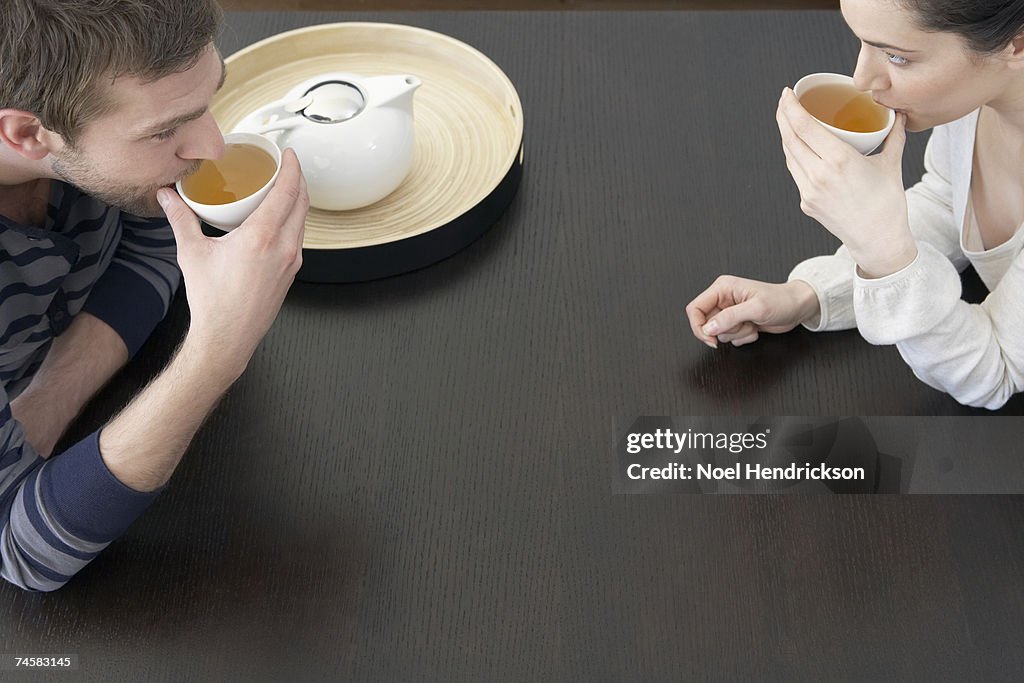 Couple drinking tea at table, elevated view