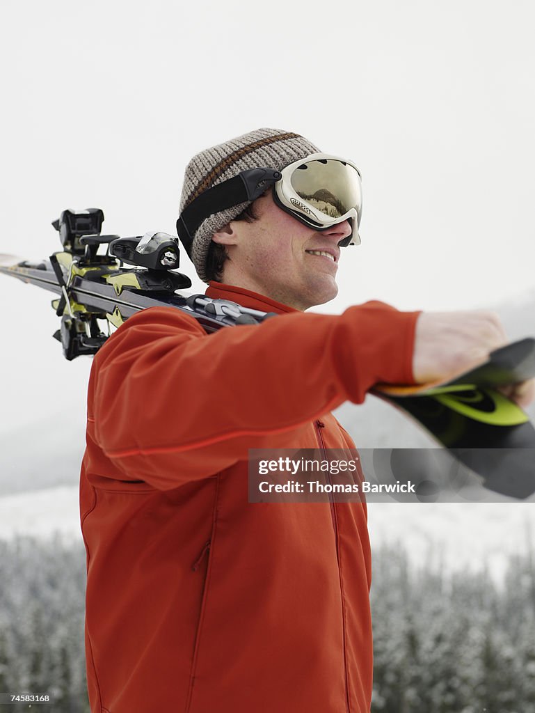 Man carrying skis wearing goggles, Joffre Pass, British Columbia, Canada