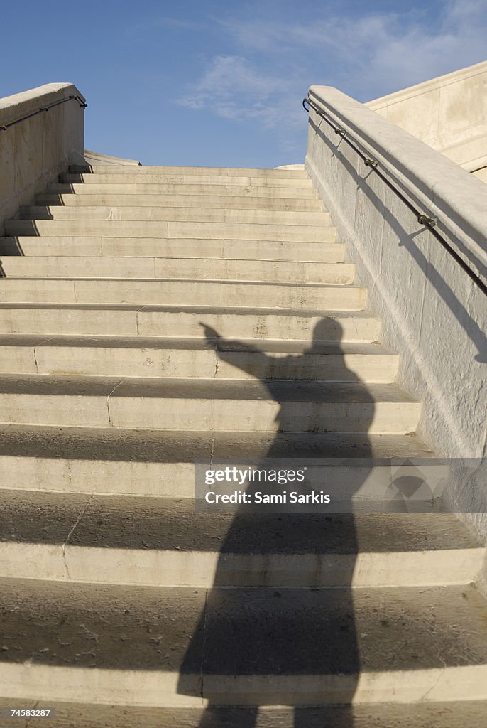 Man casting shadow on steps