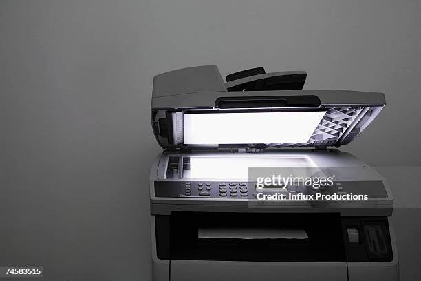 lit up photocopier with open lid - copying fotografías e imágenes de stock