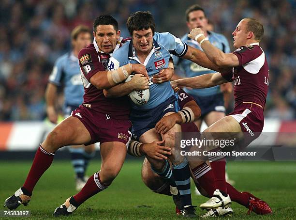 Nathan Hindmarsh of the Blues is tackled by Steve Price and Darren Lockyer of the Maroons during game two of the ARL State of Origin series between...