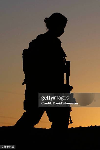 Lieutenant Sivan Ben Ezra, a 22-year-old deputy company commander in the Israeli army's Caracal battalion, is silhouetted against the sunset during...