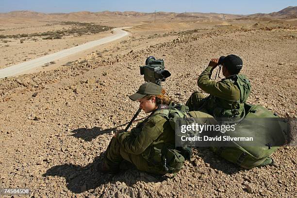 Female soldier and her male counterpart from the Israeli army's Caracal battalion search for infiltrators as they operate a mobile observation point...