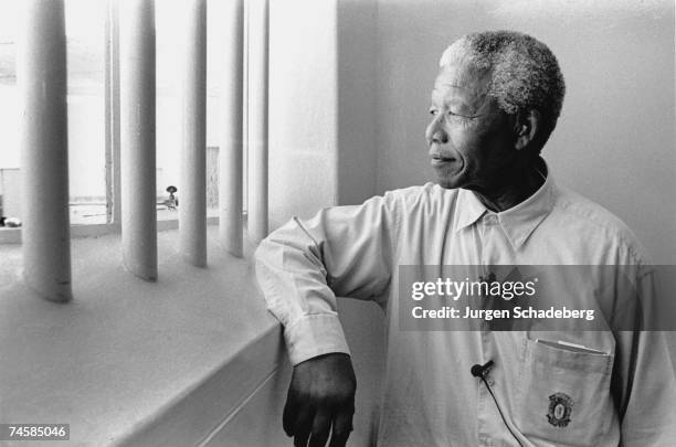 South Africa's first black President Nelson Mandela revisits his prison cell on Robben Island, where he spent eighteen of his twenty-seven years in...