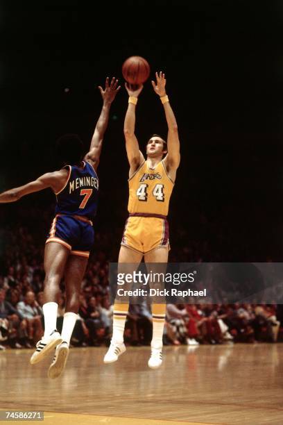Jerry West of the Los Angeles Lakers shoots a jump shot against Dean Memninger of the New York Knicks during a 1975 NBA game at the Forum in Los...