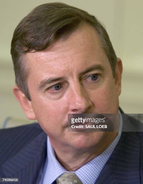 Washington, UNITED STATES: Ed Gillespie, former chairman of the Republican National Committee, listens as US President George W. Bush announces...