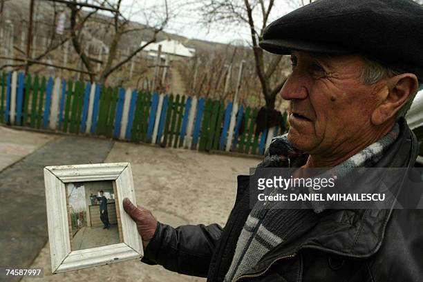 File picture of a 24 years old young man who died one year after he sold his kidney is shown by his father, Vasile Dimineti, in the village of...