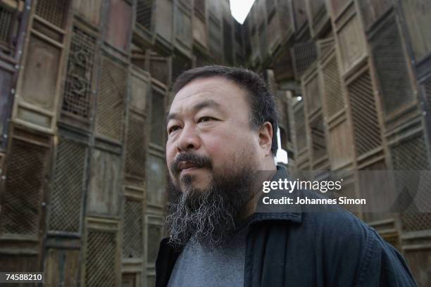 Chinese Artist Ai Weiwei poses in front of his sculpture 'Template' during a media preview of Documenta 12 on June 13, 2007 in Kassel, Germany. The...