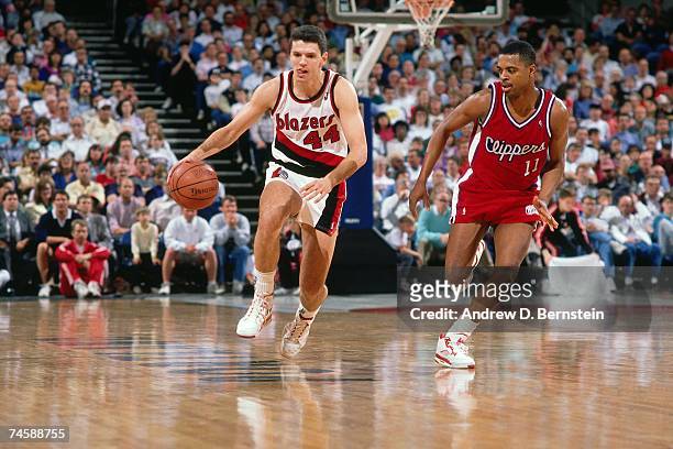 Drazen Petrovic of the Portland Trail Blazers dribbles upcourt against the Los Angeles Clippers during a 1990 NBA game at the Rose Garden in...