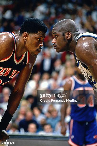 Patrick Ewing of the New York Knicks matches up against Shaquille O'Neal of the Orlando Magic during a 1995 NBA game at the Orlando Arena in Orlando,...