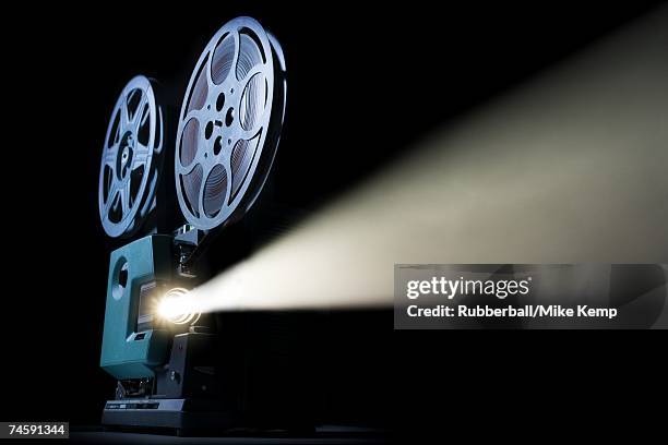 movie projector with beam of light - film projector stock pictures, royalty-free photos & images