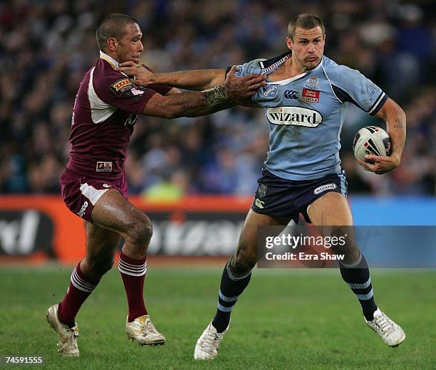 Matt Cooper of the Blues fends off Justin Hodges of the Marrons during game two of the ARL State of Origin series between the New South Wales Blues...