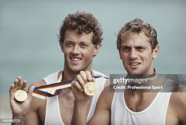 British rowers Andy Holmes and Steve Redgrave of the Great Britain team pictured holding their gold medals after finishing in first place in the...