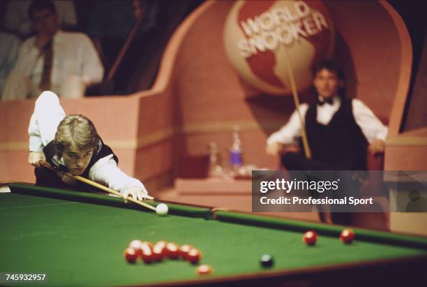 Scottish professional snooker player Stephen Hendry pictured in action against Jimmy White in the final of the 1990 Embassy World Snooker...