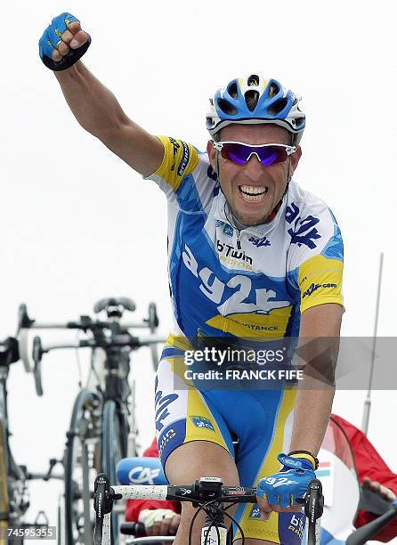 Beaumont-du-Ventoux, FRANCE: French Christophe Moreau raises his arm in victory as he crosses the finish line of the fourth stage of the Dauphine...