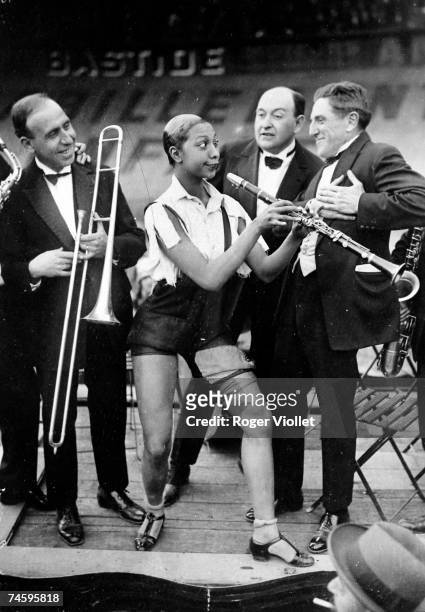 American music hall star Josephine Baker , playing the clarinet at the Caf' Conc festival at the Stade Buffalo velodrome, Montrouge, Paris, 1926....