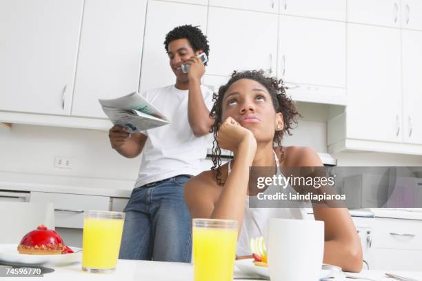 frustrated african woman in kitchen with boyfriend - cheese ball stock pictures, royalty-free photos & images